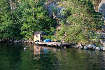 Fisherman hut, Sweden, Archipelago of Stockholm. Reflection in water of fishing cabin against nature