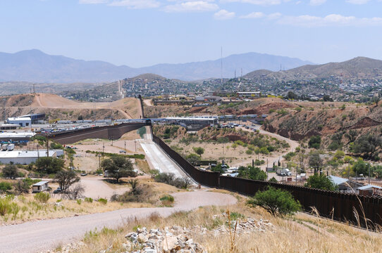 A panoramic view of the United States southern border with Mexico where the border wall and the international point of entry are visible