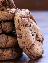 chocolate cookies with chocolate chips on a wooden table