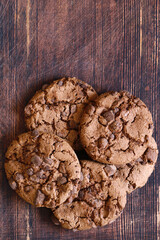chocolate cookies with chocolate chips on a wooden table