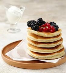 stack of pancakes with fresh berries for breakfast
