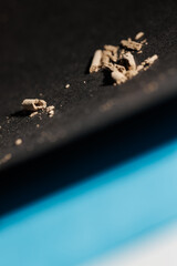 Angled view of ashes on a blue-black textured background for graphic and web design use