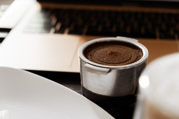 coffee on the desktop near the laptop . lunch at work