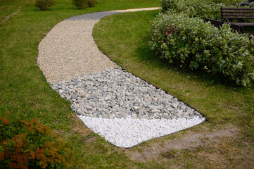 Tactile massage eco-trail with different textures in park for walking barefoot, pebbles, stones, sawdust. Prevention of flat feet, strengthening immune system