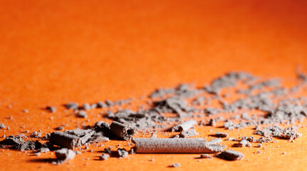 Close up of ashes on the blurry orange floor for graphic and web design use 