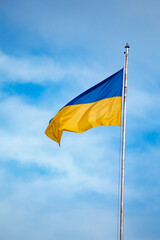 National flag of Ukraine against blue sky