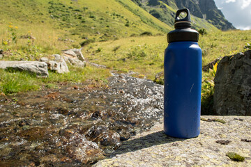  Eco-Friendly Water Bottle by a Mountain Stream - 763379188