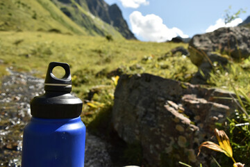  Eco-Friendly Water Bottle by a Mountain Stream - 763379366