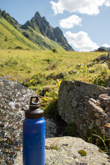  Eco-Friendly Water Bottle by a Mountain Stream - 763379387