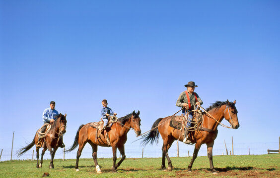 Rancher, his son and grandson on horseback; Howes, South Dakota, United States of America