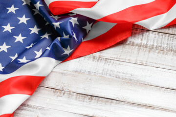 American flag on a rustic wooden background, top view, copy space. Symbol of independence, patriotism.