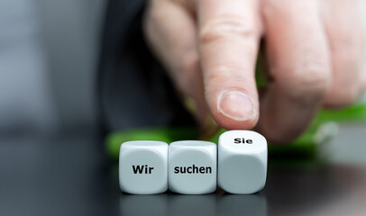 Wooden cubes form the German expression 'wir wollen sie' (we want you).