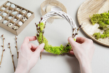 Florist at work: woman shows how to make simple Easter candle holder using a random glass and moss....