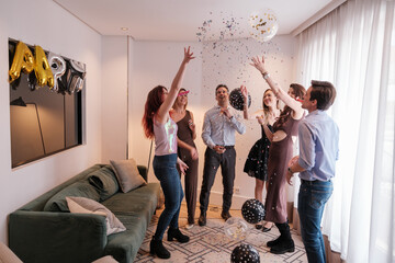 Group of friends dancing and singing at a floor party celebrating together. Concept: fun