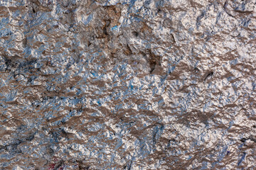 Rose silver colored old concrete wall with very uneven texture