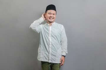 Asian muslim man thinking worried about a question, concerned and nervous with hand on chin