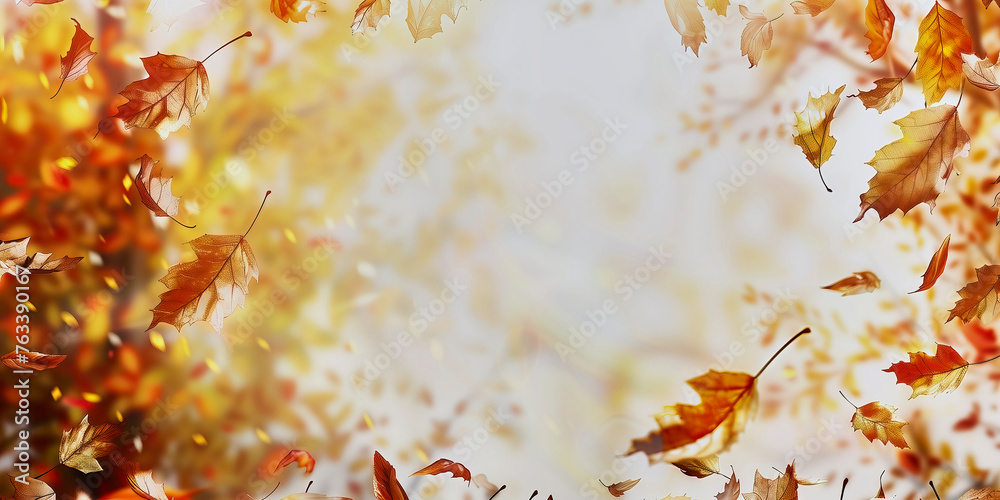 Wall mural warm autumn backdrop with falling leaves on a blurred golden light background