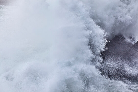 Powerful spray of a storm surf; Arnastapi, Iceland