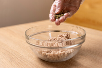 Pepper and spices are added to the chicken. Cooking chicken dishes.