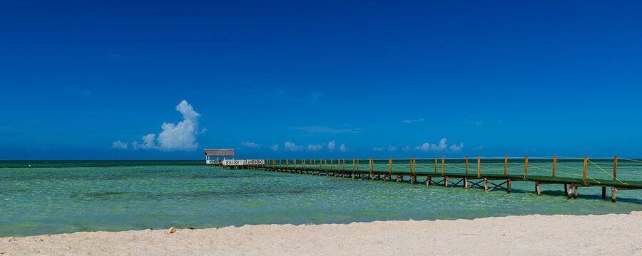 View of a jetty in the turquoise water off the sandy beach of a resort in Cayo Guillermo; Cayo Guillermo, Cuba