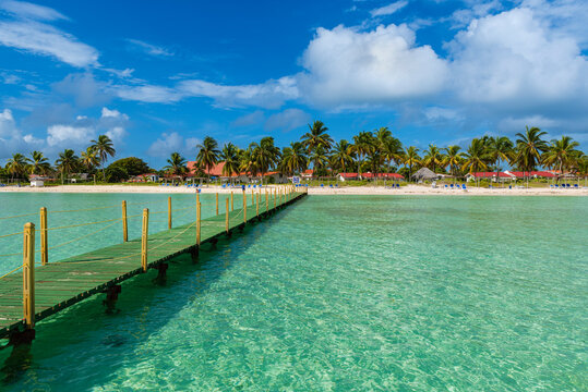 Resort beach with pier along the coastline at Cayo Guillermo in the Jardines del Rey archipelago; Cayo Guillermo, Cuba