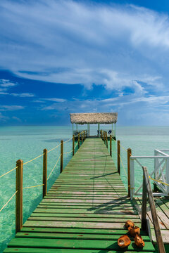 Pier of a hotel at Cayo Guillermo in the Jardines del Rey archipelago, with clear turquoise water and the horizon in the distance; Cayo Guillermo, Cuba