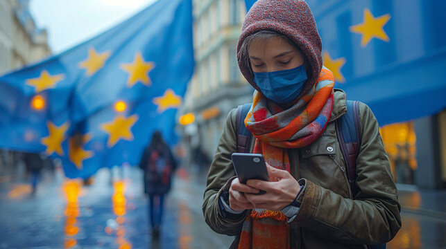Woman wearing mask using mobile phone with an EU flag on the streets of Europe