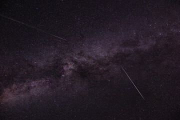Milky way stars and shooting stars photographed with wide angle lens. - obrazy, fototapety, plakaty