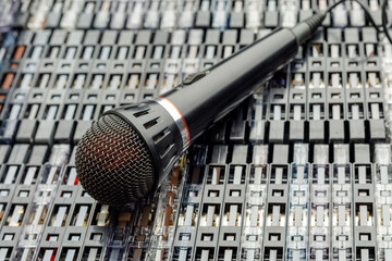Tabletop view - stacked audio cassettes and microphone on them