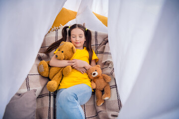 Photo portrait of cute small girl lying floor tent hug toy closed eyes sleeping dressed stylish yellow clothes modern playroom interior © deagreez