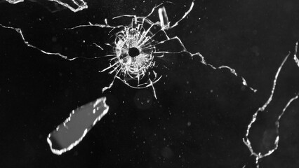 Close-up of gunshot through the glass, shattering against the black background - 763401911