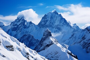 Fototapeta na wymiar Snow-covered mountain peaks under a clear blue sky background