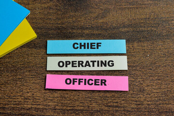 Concept of Chief Operating Officer write on sticky notes isolated on Wooden Table. - obrazy, fototapety, plakaty