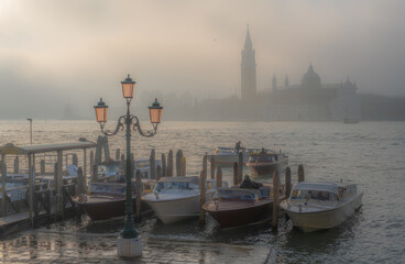 Gondolas in Venice at sunrise in morning fog. Veneto, Italy.. - 763414338