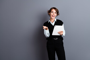 Photo of adorable confident lady wear stylish clothes hold ipad communicate tell report empty space...
