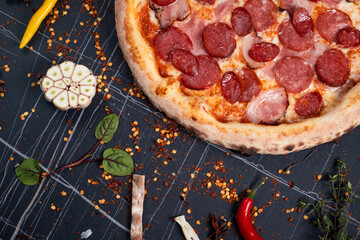 Slices of pizza on rustic wooden tray and dark background