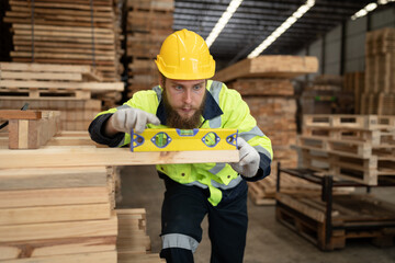 Caucasian businessman checking and use precision level to wood timber at warehouse  - 763416525