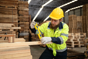 Caucasian businessman checking and use precision level to wood timber at warehouse  - 763416526