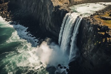 Aerial view of a dramatic waterfall cascading down rocky cliffs
