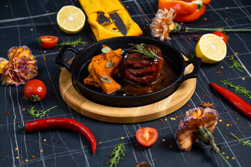 Grilled Fillet Mignon Steak with roasted asparagus. Black background. Top view.
