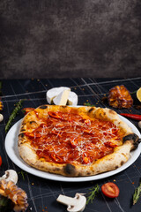 Traditional italian pizza pepperoni with salami and cheese on a dark slate, stone, metal or concrete background.Top view with copy space.