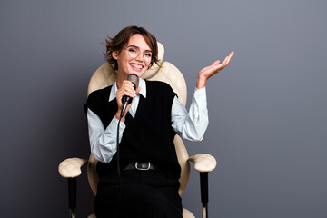 Photo of cheerful woman with bob hairstyle wear formalwear in glasses sit in armchair talk in...