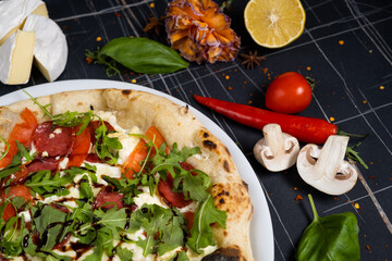 Salmon and arugula pizza. Light and tasty restaurant meal for a foodie