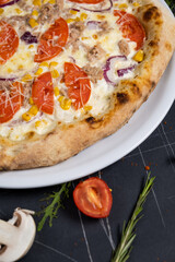 pizza tuna on black background top view