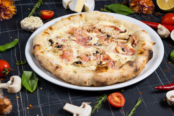 Bacon Pizza. Italian Carbonara Pizza with bacon and mozzarella cheese on black table, top view, close up.