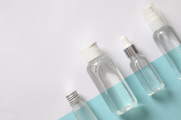 Various transparent bottles on a colored background
