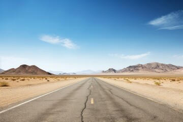 Fototapeta na wymiar An empty road cutting through a stark, arid desert landscape