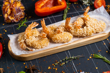 Fried Shrimps tempura with sweet chili sauce on black board stone