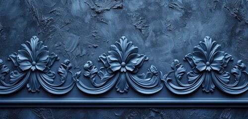 Decorative relief on a textured navy blue stucco wall. Wide-angle shot, abstract patterns. Steel blue background.
