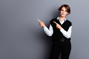 Photo of pretty charming lady accountant dressed black vest eyewear pointing two fingers empty...